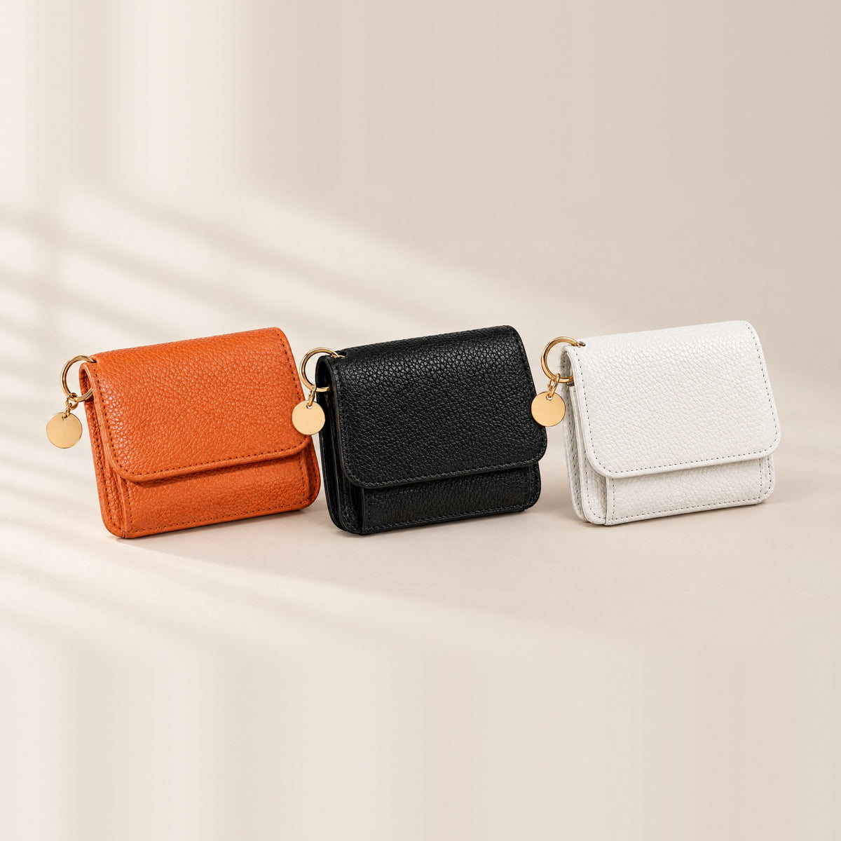 TravelSmart Bella Women's RFID Wallet in all three colours, orange, black and white, standing side by side