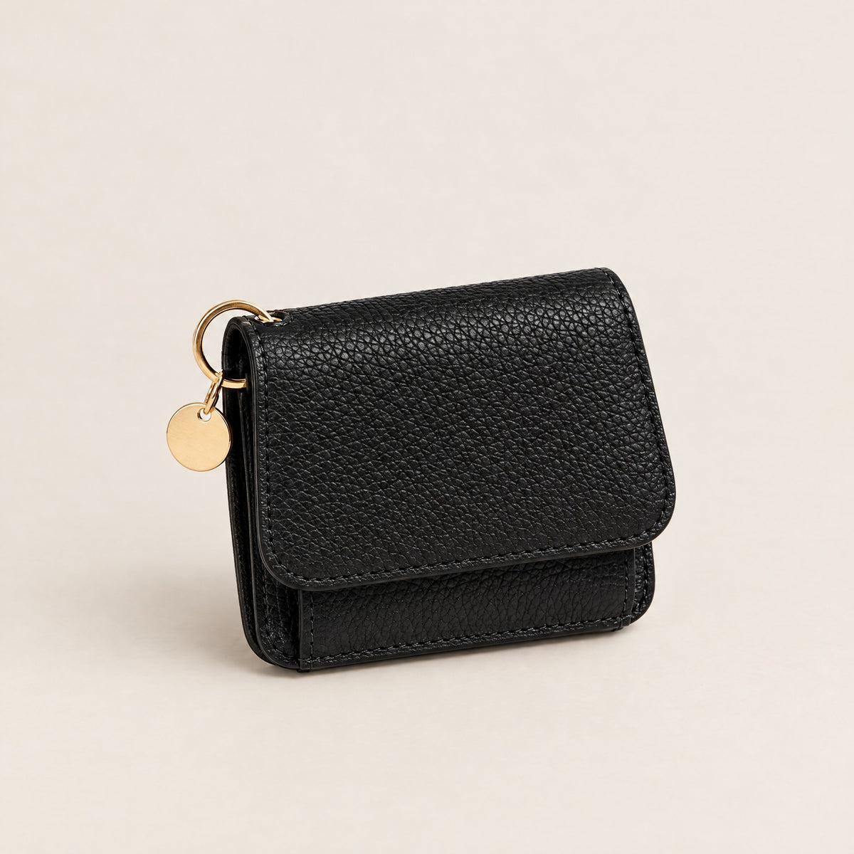 TravelSmart Bella Women's RFID Wallet in black, closed front view with gold ring and disc charm