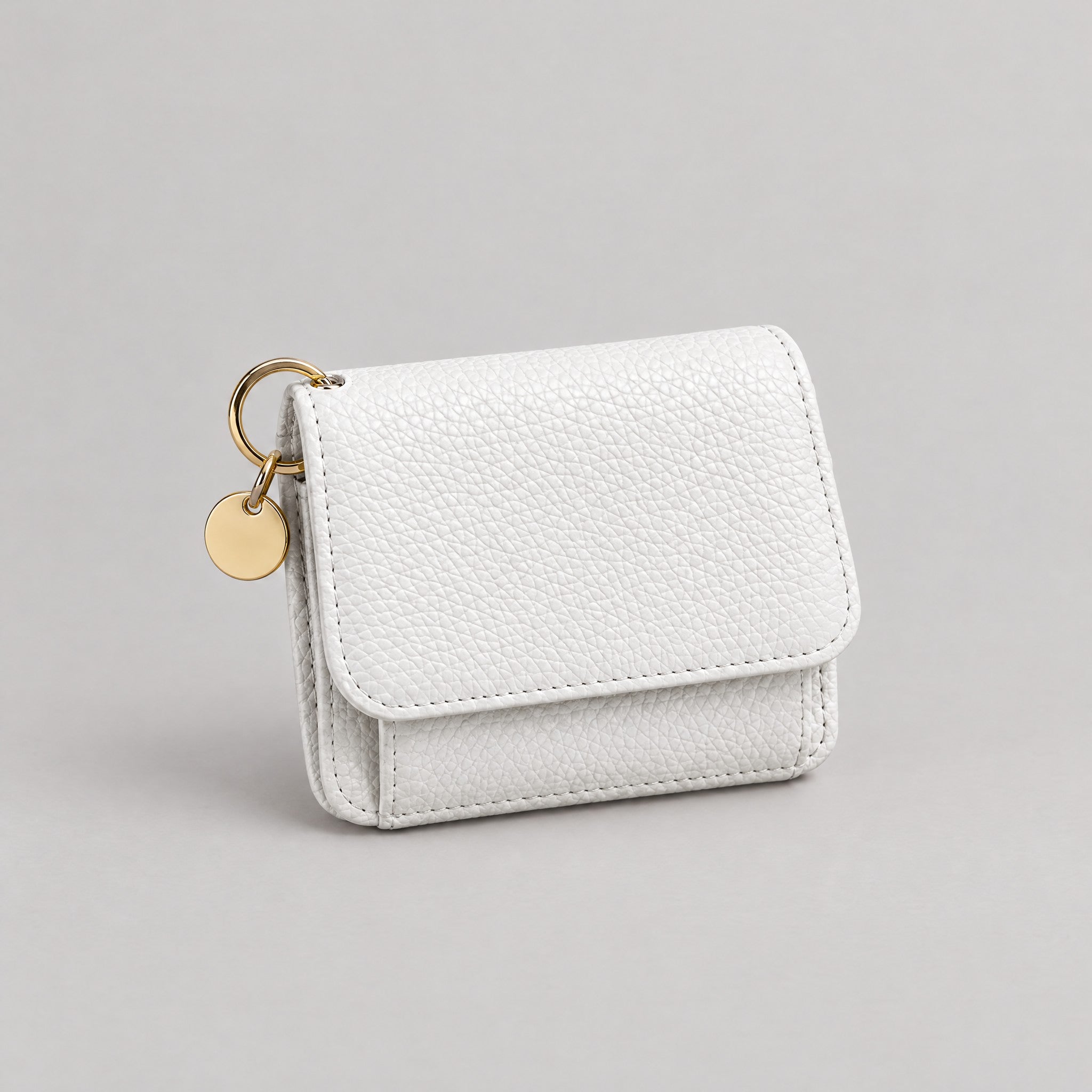 TravelSmart Bella Women's RFID Wallet in white, closed front view with gold ring and disc charm